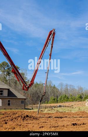 Bei der Vorbereitung auf das Fundament wird Zementbeton gegossen, der eine automatische Pumpe leitet Stockfoto