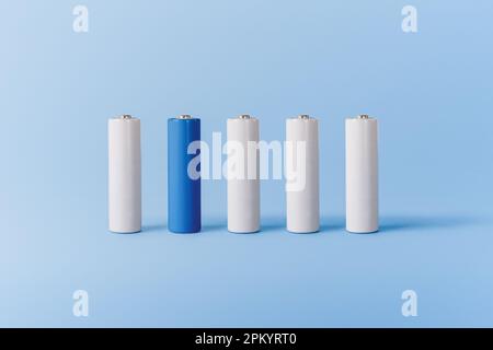Satz mit verschiedenen weißen und blauen Batterien auf blauer Oberfläche Stockfoto
