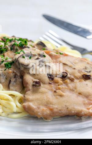 Schweinefilet mit Pilzsauce serviert mit Spatzles Stockfoto