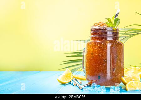 Südlicher Sweet Tea Slushy. Kalter Sommerteesüß-Dessert, hergestellt aus zerdrücktem Eistee und Zitronensaft, auf sonniger blauer Holzunterlage Stockfoto