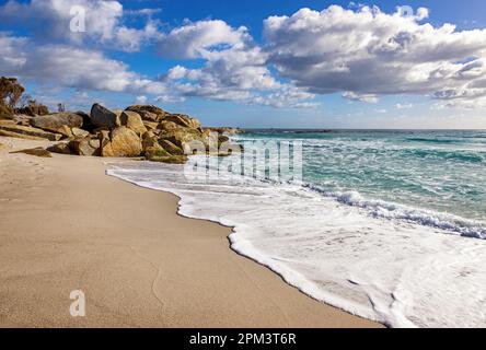 Flechten bedeckte Felsen in der Bucht der Feuers, Osttasmanien. Sommerhimmel mit sanften Wellen am Sandstrand. Stockfoto