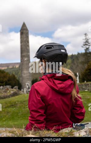 Traveler Woman Cyclist am St. Kevin Church in Glendalough Stockfoto