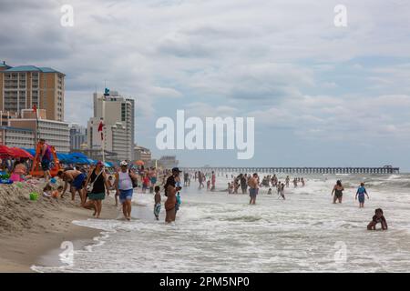 An einem bewölkten Tag im Myrtle Beach, South Carolina, USA, drängen sich Urlauber an die Küste. Stockfoto