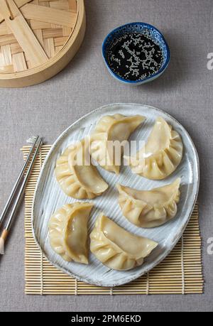 Gyoza japanisch koreanische Knödel auf grauem Teller auf dem Tisch. Stockfoto