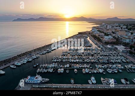 Spanien, Balearen, Mallorca, Bucht von Alcúdia, Can Picafort, sonnenaufgang über dem Hafen, im Hintergrund der Naturpark Península de Llevant und die Berge (Luftaufnahme) Stockfoto