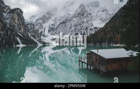 Eine kleine Holzhütte am Rande des ruhigen Braies Lake in den Dolomiten, Italien. Stockfoto