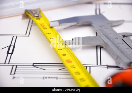 Werkzeuge und Papiere mit Skizzen-Blueprint auf dem Tisch Stockfoto