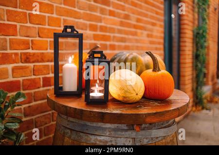 Stilvolle Tischdekoration mit brennender Kerze. Restaurant im Freien am Ufer. Stockfoto