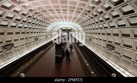 Eine Gruppe von Personen steht auf einem Bahnsteig der U-Bahn und wartet auf den nächsten Zug. Stockfoto