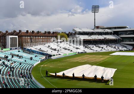 Das Kia Oval, London, Großbritannien. 13. April 2023. Bodenpersonal entfernt die Abdeckungen nach Regen während der Mittagspause am 1. Tag des Spiels LV=Insurance County Championship Division One zwischen Surrey und Hampshire: Credit: Ashley Western/Alamy Live News Stockfoto