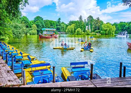 UMAN, UKRAINE - 16. JUNI 2021: Kinder segeln auf Katamaranen auf dem oberen See im Sofiyivka Park, am 16. Juni in Uman, Ukraine Stockfoto