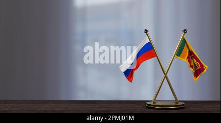 Russische und Sri-lankische Flaggen liegen auf dem Tisch. Verhandlungen zwischen Sri Lanka und Russland. Auf wenig unscharfem Hintergrund. 3D Arbeit und 3D Bild Stockfoto