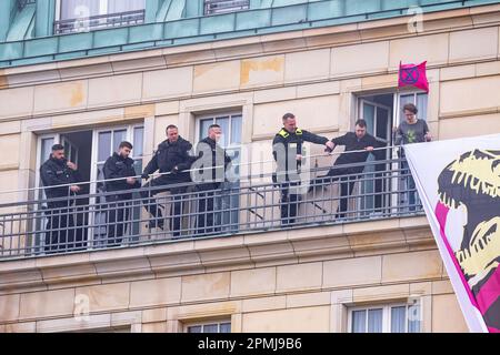 Berlin, Deutschland, 13. April 2023. Ausrottungsrebellionen-Protest Berlin 13. April 2023. Vor dem Brandenburger Tor in Berlin versammelten sich Demonstranten, darunter Mitglieder der aussterbenden Rebellion . Einige Demonstranten hatten das Adlon Hotel unter den Linden betreten und ein Banner enthüllt, auf dem stand: "Wir können uns die Superreichen nicht leisten" und ließen Fackeln los, bevor sie von der Polizei entfernt wurden. Berlin Deutschland. Foto: Garyroberts/worldwidefeatures.com Stockfoto