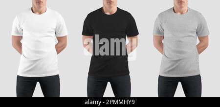 Weiß, schwarz, meliertes T-Shirt-Modell eines Mannes mit Händen hinter dem Rücken, stilvolle Kleidung für Design, Branding, Frontansicht. Bekleidungsset für Handel, Werbung. Stockfoto