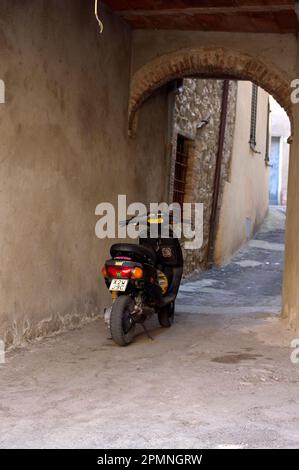 Casciano di Murlo, Italie, 26.07.2010. Ein Roller steht in der engen Gasse. Stockfoto