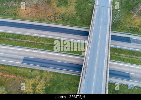 Luftaufnahme einer Landstraße ohne Verkehr, umgeben von üppiger grüner Vegetation Stockfoto