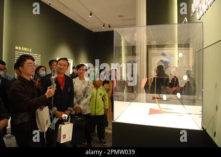 Hangzhou, Ost-Chinas Provinz Zhejiang. 14. April 2023. Besucher sehen „Four White Discs and Red Rubber“ von Alexander Calder im Hangzhou-Pavillon des Meet You Museums in Hangzhou, Ost-Chinas Provinz Zhejiang, 14. April 2023. Der Hangzhou Pavillon des Meet You Museums wurde am Freitag offiziell eröffnet. Am Eröffnungstag wurden zwei Ausstellungen mit Kunstwerken bekannter westlicher Künstler wie Vincent van Gogh und Claude Monet für die Öffentlichkeit eröffnet. Kredit: Weng Xinyang/Xinhua/Alamy Live News Stockfoto