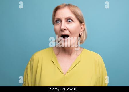 Nahaufnahme einer schockierten blonden Frau mittleren Alters Stockfoto
