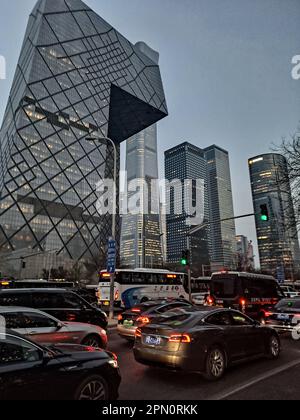 Stau in der Hauptverkehrszeit nach der Arbeit zwischen dem CCTV Tower und den Geschäftsgebäuden im zentralen Geschäftsviertel am Abend, Peking, China. Stockfoto