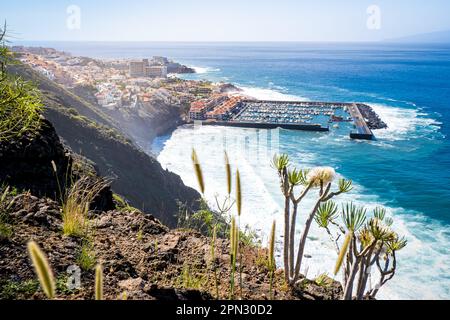 Panoramablick von einer hoch aufragenden Klippe auf das Dorf Los Gigantes, den Hafen Puerto de Los Gigantes und den Strand Playa Los Guíos. Stockfoto