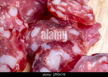 Geschnittene Wurst aus Fleischstücken mit Speck, köstliche frische Wurst mit Gewürzen Stockfoto