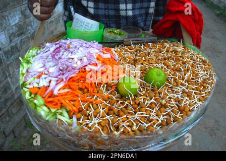 Kichererbsen, Zitronen, Gurken, rohe Chilischoten, Tamarindenpaste in Körben werden zum Verkauf gehalten. Stockfoto