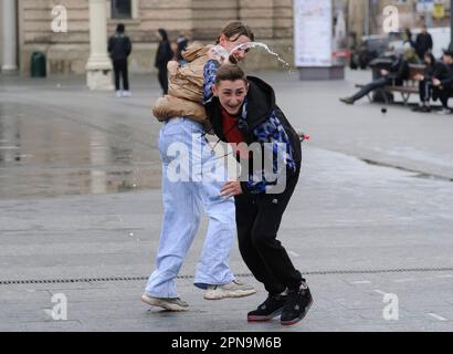 Lemberg, Ukraine. 17. April 2023. Die Ukrainer gießen sich auf der Straße im Stadtzentrum inmitten der russischen Invasion in die Ukraine gegenseitig Wasser. Der Brauch des Wassertauchens ist ein uralter Ritus der Frühjahrspülung, der am Ostermontag stattfindet. (Foto: Mykola Tys/SOPA Images/Sipa USA) Guthaben: SIPA USA/Alamy Live News Stockfoto
