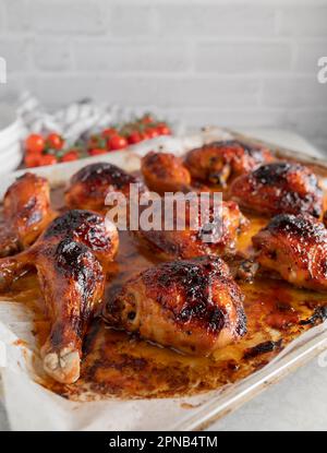 Im Ofen gebackenes Hähnchen, glasiert mit Barbecue-Sauce auf einem Backblech Stockfoto
