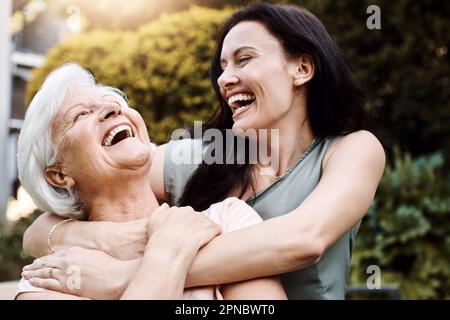 Sie haben denselben Sinn für Humor. Eine glückliche Seniorin, die Zeit mit ihrer Tochter im Freien verbringt. Stockfoto