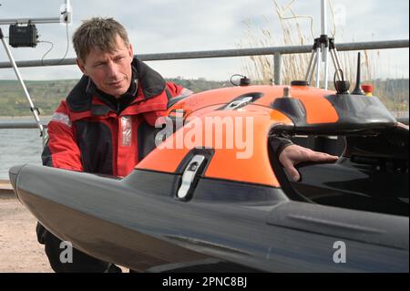 Aseleben, Deutschland. 18. April 2023. Sven Thomas, Projektmanager und Unterwasser-Archäologe, arbeitet mit einer schwimmenden Sonobot-Drohne, die den Grund des Sees mit Sonar scannen und anzeigen kann. Diese moderne Technologie wird zum ersten Mal bei der Suche nach archäologischen Schätzen unter Wasser auf dem Grund des Süßener Meeres eingesetzt. Kredit: Heiko Rebsch/dpa/Alamy Live News Stockfoto