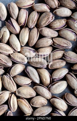 Pistazientextur und Hintergrund. Köstliche Erdnüsse als Hintergrund. Hintergrund aus gesalzenen Pistazien (in der Schale). Stockfoto