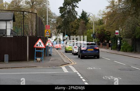 Eine Warteschlange mit Verkehr, die an einem temporären Ampelsignal wartet. Stockfoto