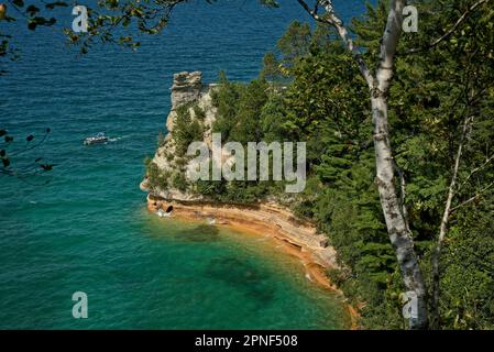 Ein kleines Tourboot fährt am Miners Castle am Pictured Rocks National Lake Shore am Lake Superior, Michigan vorbei. Stockfoto