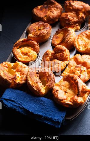Speisekonzept hausgemachter Yorkshire Pudding auf schwarzem Hintergrund mit Kopierbereich Stockfoto