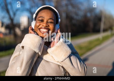 Außenporträt einer glücklichen schwarzen Frau am sonnigen Tag. Stockfoto