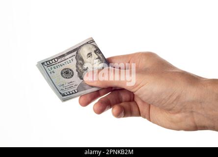 Man Hand gibt 100-Dollar-Scheine isoliert auf weißem Hintergrund. Hundert US-Dollar Stockfoto