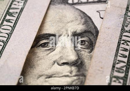 Extreme Nahaufnahme von hundert Franklin-Porträts. Makro. Amerikanisches Papiergeld. Ein $$100-Gesetz mit Schwerpunkt auf Benjamin Franklin. US-Banknoten Stockfoto