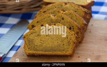 Frisch gekochter Glutenkuchen, in Scheiben geschnitten, ordentlich auf einem Holzbrett angeordnet Stockfoto