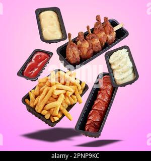Schwimmender Fast-Food-Snack und pommes frites vor rosafarbenem radialem Hintergrund Stockfoto