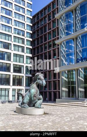 Basel, Schweiz - August 10. 2021: Die bronzene imaginäre Tierfigur im Baloise Park mit hohen Geschäftsgebäuden hinter dem Zentrum von rai Stockfoto