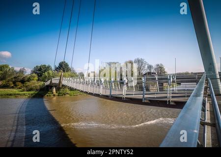 19.04.023 Lancaster, Lancashire, Vereinigtes Königreich. Die Lune Millennium Bridge ist eine Fußgängerbrücke mit Kabelhalterungen, die sich über den Fluss Lune in Lancaster, England erstreckt. Stockfoto