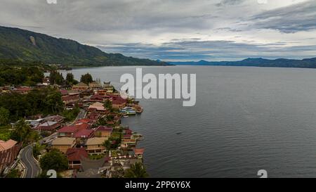 Luftaufnahme des Toba-Sees und der Insel Samosir. Tuk Tuk traditionelles Dorf und Touristenziel. Sumatra, Indonesien. Tropische Landschaft. Stockfoto