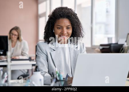 Geschäftsfrau mittleren Alters, die auf einem Touchscreen-Notebook arbeitet, surft und tippt. Stockfoto