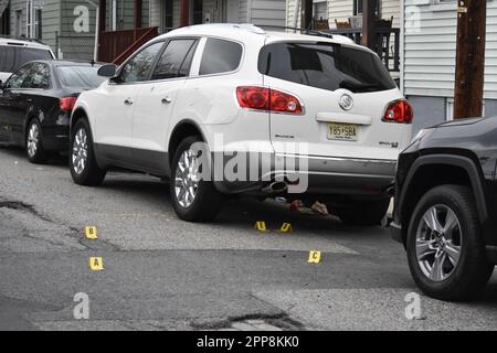 Paterson, Usa. 22. April 2023. Beweismarkierungen und Patronenhülsen verstreuen die Straße am Tatort. Samstagnachmittag wurde gegen eine Schießerei in der Beech Street ermittelt. Auf dem Boden wurden Patronenhülsen vorgefunden, und es wurden keine Verletzungen gemeldet. Die Polizei von Paterson sperrte die Straße für eine Weile, während sie den Tatort in der Beech Street untersuchten. (Foto: Kyle Mazza/SOPA Images/Sipa USA) Guthaben: SIPA USA/Alamy Live News Stockfoto