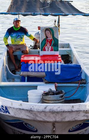 Mexikanischer Fischer mit einer Jungfrau-de-Guadelupe-Ikone auf seinem Boot. Yucatan Küste Mexiko Stockfoto