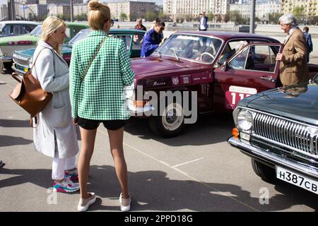 Die Leute untersuchen eine sowjetische Gaz-24 "Volga", die in der Nähe des Gorky-Parks in Moskau parkt. An der Retro Rally „Capital“ (Stolitsa) 2023 in Moskau, Russland, nahmen über 100 Retro-Autos Teil. Diese Veranstaltung eröffnet eine Reihe offizieller Wettbewerbe der Saison 8. des Russian Automobile Federation Cup in Rallye-Rennen mit Oldtimern. Legendäre sowjetische Marken wie „Volga“, „Moskvich“ und „Zhiguli“ sowie weltberühmte Marken wie Rolls Royce, Bentley, Mercedes, Porsche, Jaguar, Und andere. (Foto: Vlad Karkov/SOPA Images/Sipa USA) Stockfoto