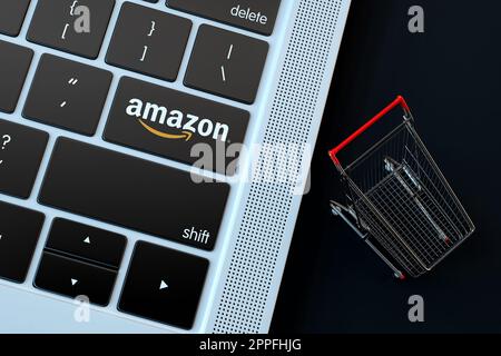 Amazon-Logo auf Laptop-Tastatur und Miniatur-Warenkorb. 3D-Rendering Stockfoto