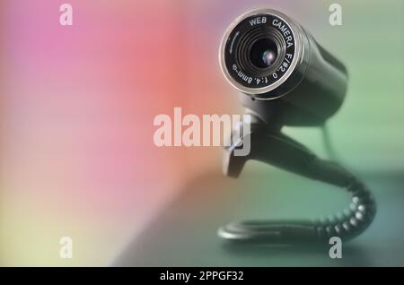 Kabelgebundene Webkamera, die auf der Computeroberfläche liegt. Nahaufnahme Stockfoto