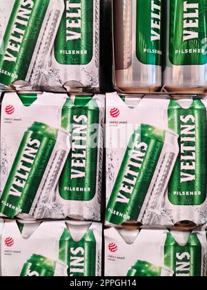 Kiel, Germany - 20. August 2022: Numerous cans of Veltins beer on a supermarket shelf. Stockfoto