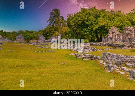 Iguana-Eidechse in den alten Ruinen der Maya in der archäologischen Zone El Rey bei Cancun, Yukatan, Mexiko mit dem Nachthimmel der Milchstraße-Galaxie Stockfoto